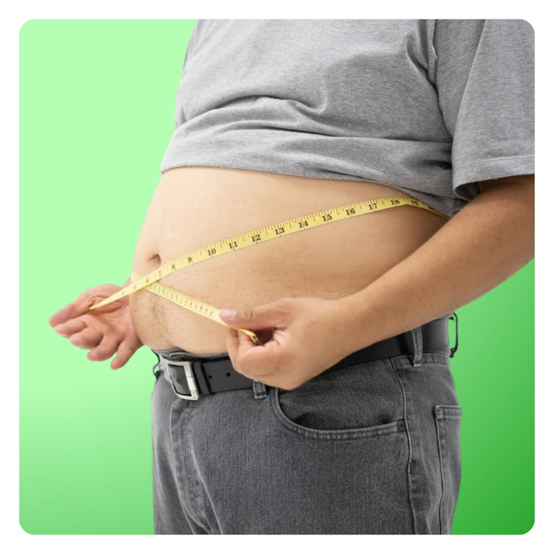 Man measuring his belly with a yellow tape measure, illustrating weight loss goals and stubborn body fat.